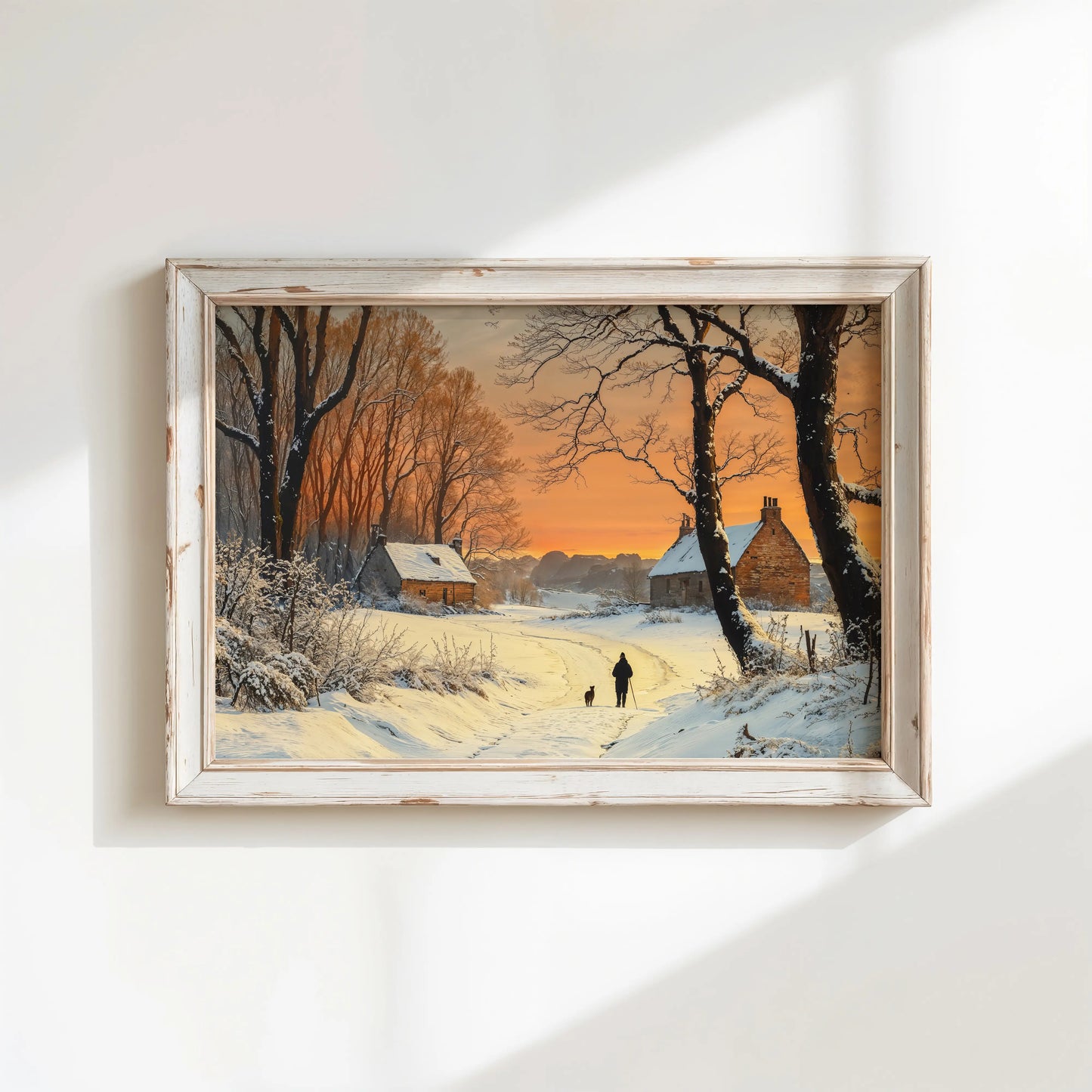 Framed winter landscape painting with a sunset over a snowy village.