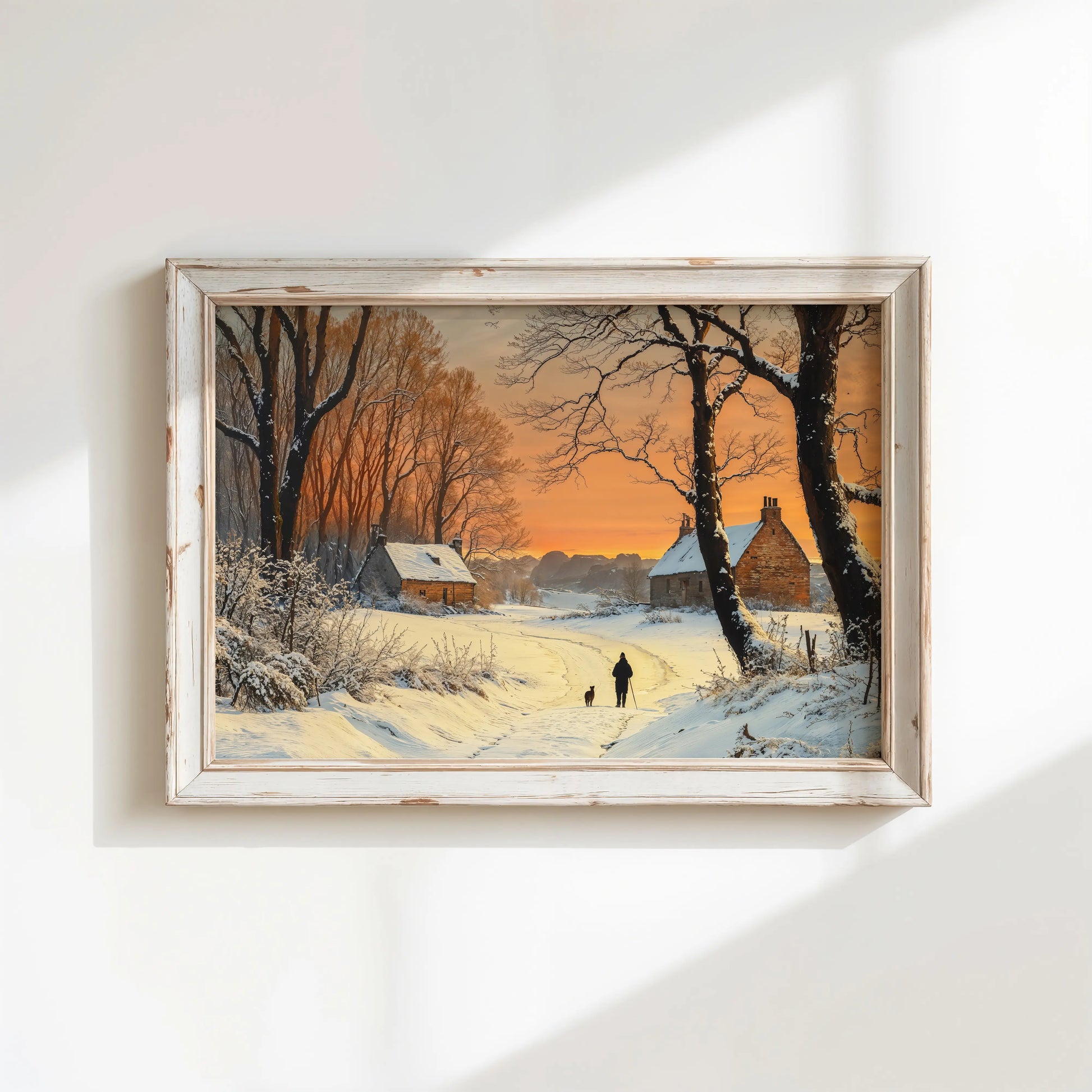 Framed winter landscape painting with a sunset over a snowy village.