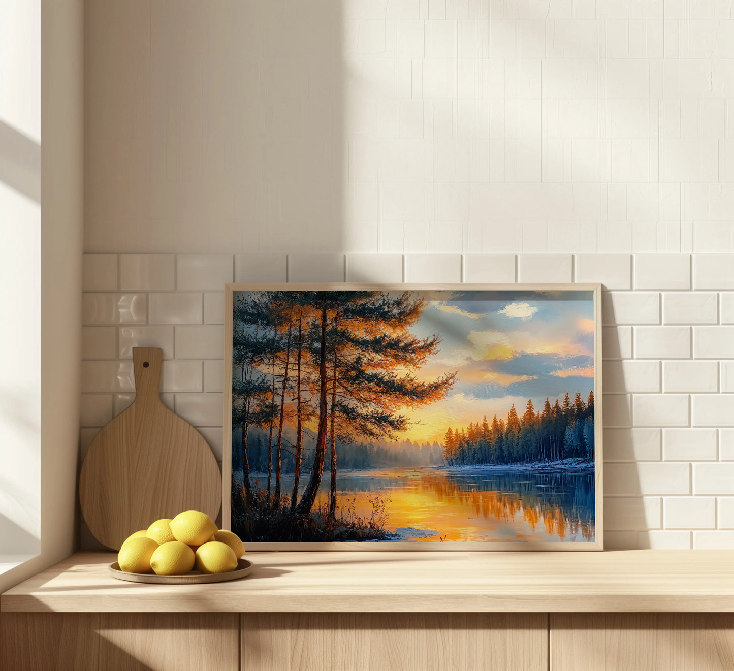 Horizontal canvas resting on a shelf above a cabinet, featuring a sunset forest reflection in a calm, neutral interior.